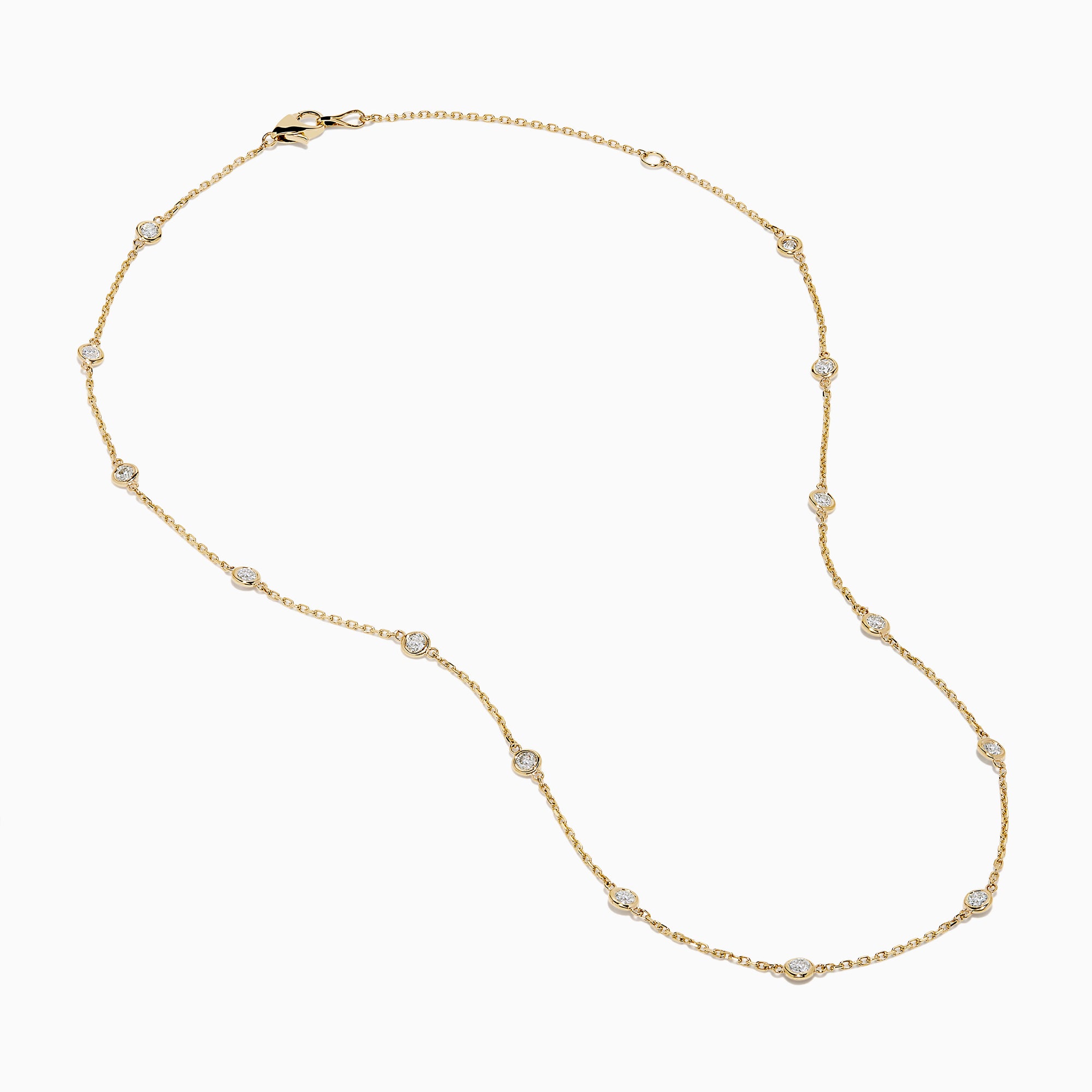 The 14K Yellow Gold Diamond Station Necklace, 1.00 TCW, features evenly spaced round diamonds in bezel settings on a delicate gold chain, shown elegantly against a white background.