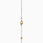 The 14K Yellow Gold Diamond Station Necklace, 1.00 TCW, features evenly spaced round diamonds in bezel settings on a delicate gold chain, shown elegantly against a white background.