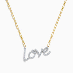 The 14K Two Tone Gold Diamond Love Necklace features a cursive love pendant adorned with sparkling diamond-clear stones.