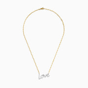 The 14K Two Tone Gold Diamond Love Necklace features a cursive love pendant adorned with sparkling diamond-clear stones.