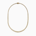 The 14K Yellow Gold Miracle Set Diamond Graduated Tennis Necklace showcases a single row of closely set, sparkling round diamonds in a gentle curve on yellow gold.