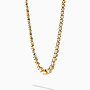 The 14K Yellow Gold Miracle Set Diamond Graduated Tennis Necklace showcases a single row of closely set, sparkling round diamonds in a gentle curve on yellow gold.