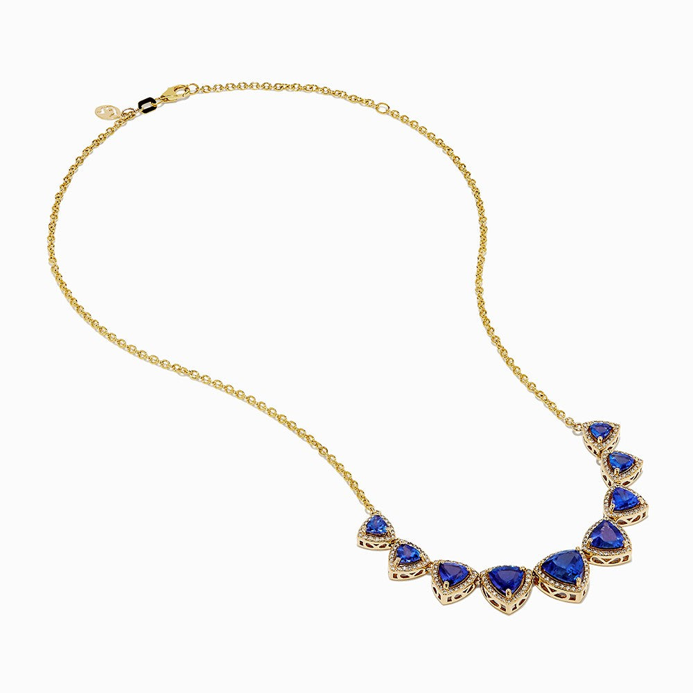 The Nahla 14K Yellow Gold Trillion Tanzanite and Diamond Necklace showcases seven deep blue trillion tanzanites, each framed by diamonds and evenly spaced along the chain.