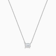 The Lab Grown Diamond Emerald Cut 1.00ct Solitaire Necklace in 14K White Gold features a sparkling emerald-cut diamond pendant, elegantly centered on a delicate white gold chain and displayed against a plain white background.