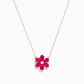 The 14K Rose Gold Ruby Flower Necklace features a pendant with six ruby gemstone petals and a small clear central stone.