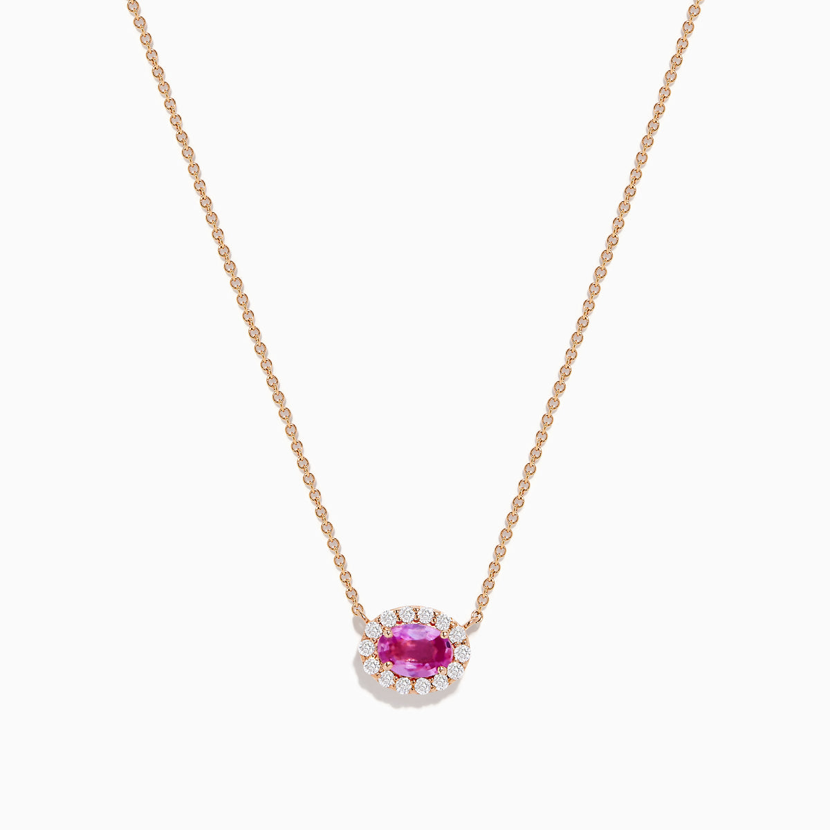The 14K Rose Gold Pink Sapphire and Diamond Necklace features an oval pink sapphire pendant surrounded by a halo of white diamonds, elegantly displayed against a white background.