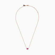 The 14K Rose Gold Pink Sapphire and Diamond Necklace features an oval pink sapphire pendant surrounded by a halo of white diamonds, elegantly displayed against a white background.