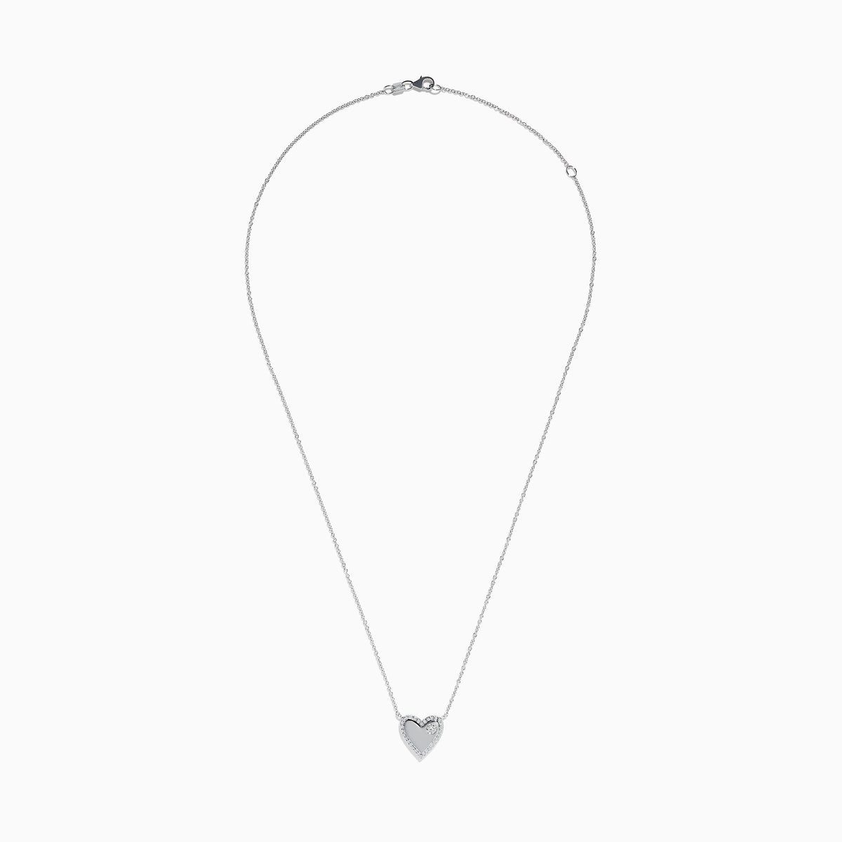 The 14K White Gold Diamond Heart Necklace showcases a heart-shaped pendant outlined with small diamonds and accented by a single larger diamond on one side, displayed against a plain white background.
