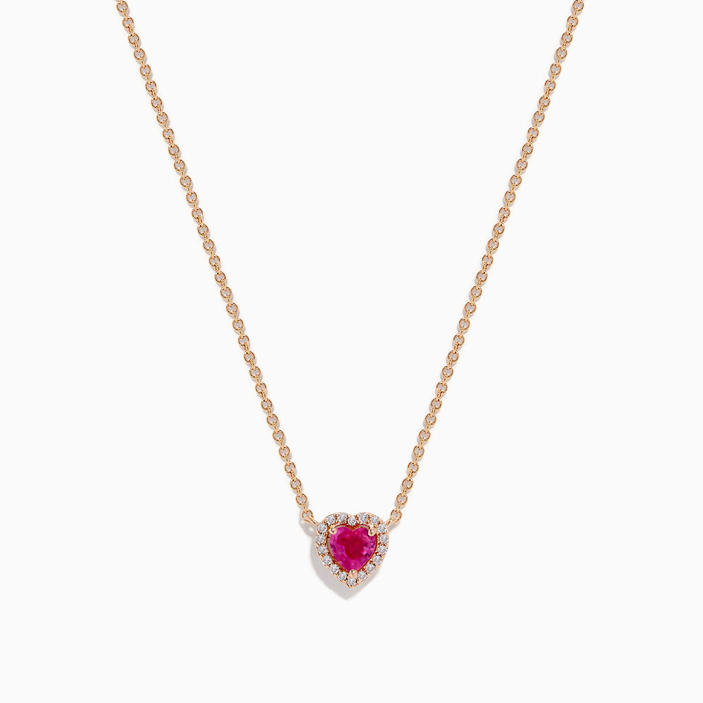 The Novelty 14K Rose Gold Pink Sapphire and Diamond Heart Necklace features a rose gold chain with a heart-shaped pendant showcasing a central pink sapphire surrounded by sparkling diamonds.