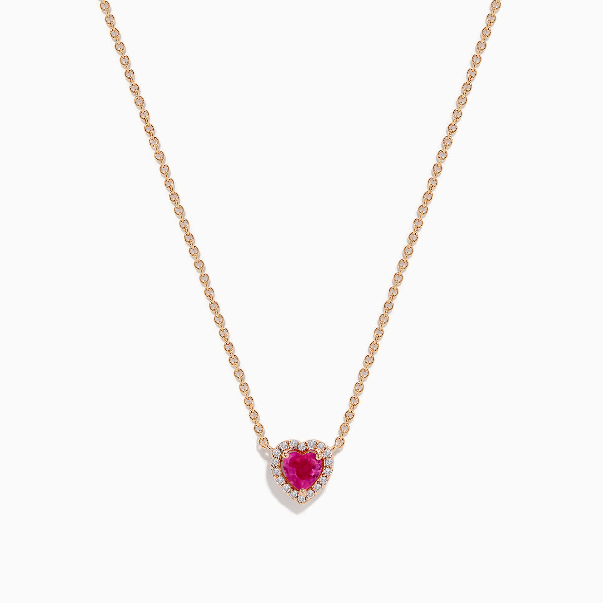 The Novelty 14K Rose Gold Pink Sapphire and Diamond Heart Necklace features a rose gold chain with a heart-shaped pendant showcasing a central pink sapphire surrounded by sparkling diamonds.