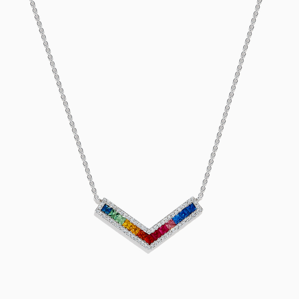 The Watercolors 14K White Gold Multi Sapphire and Diamond Collarbone Necklace features a V-shaped pendant with square, multicolored sapphires in a rainbow pattern, bordered by sparkling diamonds.