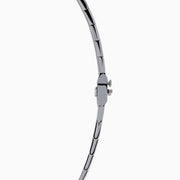 The 14K White Gold Tanzanite and Diamond Collar Necklace showcases a row of vivid blue tanzanites edged with sparkling diamonds on a sleek curved band, elegantly displayed against a white background.