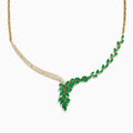 The Brasilica 14K Yellow Gold Emerald and Diamond Statement Necklace features an elegant leaf-shaped emerald on one side and sparkling diamonds on the other, meeting in a radiant V-shape at the center.