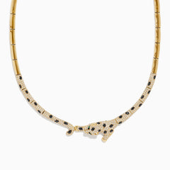 The Signature 14K Yellow Gold Diamond and Emerald Panther Necklace features a panther centerpiece adorned with black and white gemstones, sparkling diamonds, and vivid emeralds on its outstretched body.