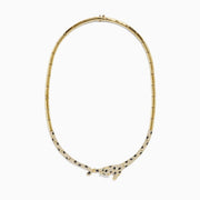 The Signature 14K Yellow Gold Diamond and Emerald Panther Necklace features a panther centerpiece adorned with black and white gemstones, sparkling diamonds, and vivid emeralds on its outstretched body.