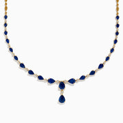 The Royale Bleu 14K Yellow Gold Blue Sapphire and Diamond Necklace features alternating teardrop-shaped blue sapphires and round diamonds, with three larger blue stones in a central drop design.