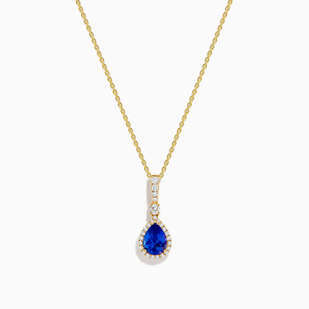 The Nahla 14K Yellow Gold Tanzanite Pendant features a teardrop blue tanzanite surrounded by diamonds and a diamond-accented bail, gleaming at the center of this elegant necklace.