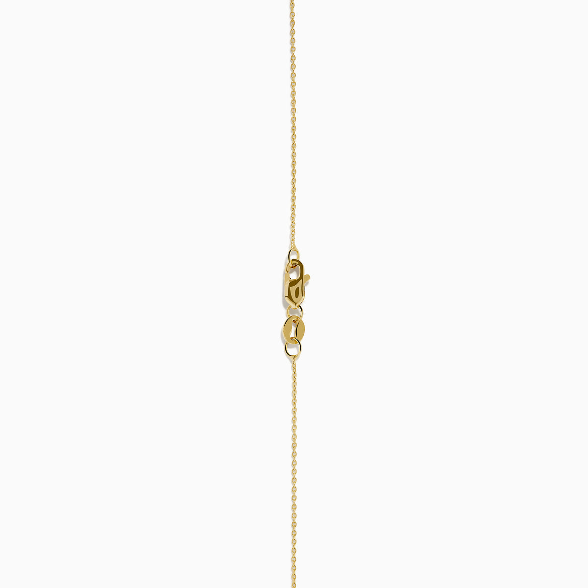The Nahla 14K Yellow Gold Tanzanite Pendant features a teardrop blue tanzanite surrounded by diamonds and a diamond-accented bail, gleaming at the center of this elegant necklace.