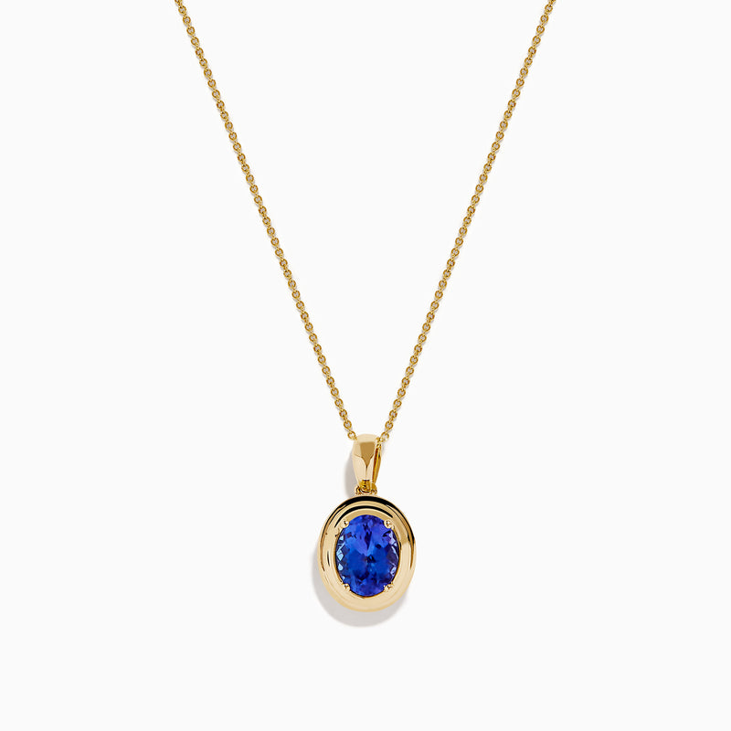 The 14K Yellow Gold Faux-Triple Bezel AAA Tanzanite Pendant features a fine chain and an oval deep blue stone, shown against a plain white background.