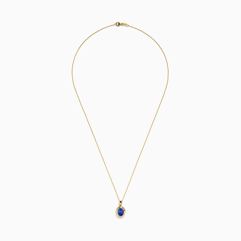 The 14K Yellow Gold Faux-Triple Bezel AAA Tanzanite Pendant features a fine chain and an oval deep blue stone, shown against a plain white background.