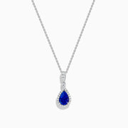 The Nahla 14K White Gold Tanzanite Pendant features a teardrop-shaped blue tanzanite accented by small white stones, set in 14K white gold and suspended from a delicate chain.