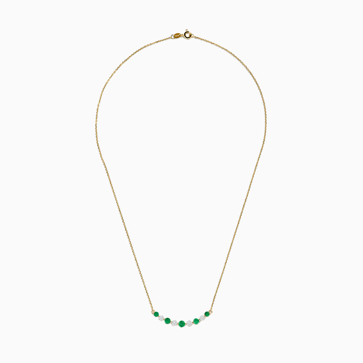 The 14K Yellow Gold Emerald and Diamond Necklace showcases alternating round emerald and diamond stones set in a gentle curve at the center.