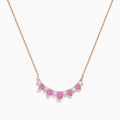 The 14K Rose Gold Pink Sapphire and Diamond Necklace features seven heart-shaped pink sapphires and six small round diamonds set in an alternating pattern along a delicate rose gold chain.