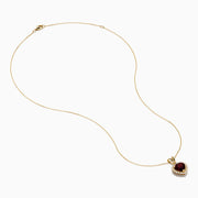 The 14 Karat Yellow Gold Rhodolite Garnet and Diamond Heart Pendant features a deep red garnet heart encircled by sparkling diamonds, elegantly suspended from a gold chain on a white background.