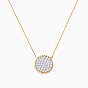 Elegant and minimalistic, the DOro 14K Yellow Gold Diamond Cluster Disc Necklace features a thin chain and a round pendant with sparkling diamonds, bordered by a delicate gold beaded edge.