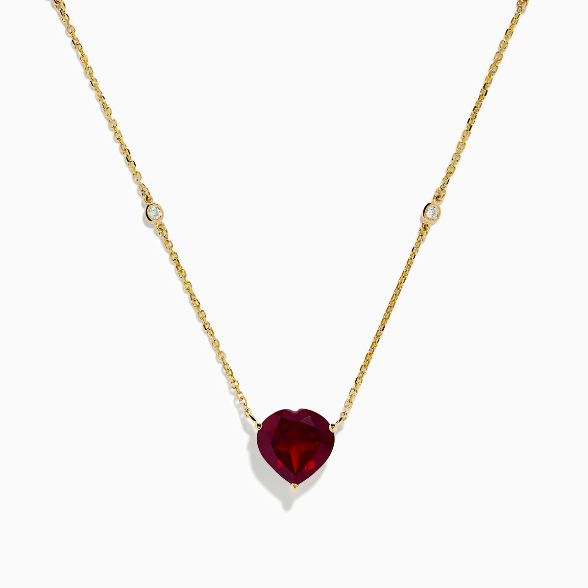 The Bordeaux 14K Yellow Gold Garnet and Diamond Heart Necklace features a heart-shaped red garnet pendant accented by two round diamonds on a delicate gold chain.