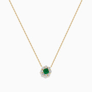 The Brasilica 14K Yellow Gold Emerald and Diamond Necklace features a round green emerald pendant with sparkling diamonds in a flower shape, set in white metal on a delicate gold chain.