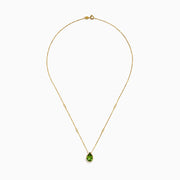 The 14K Yellow Gold Peridot and Diamond Necklace features a delicate gold chain with a teardrop-shaped green peridot pendant and two small round diamonds set along the chain.