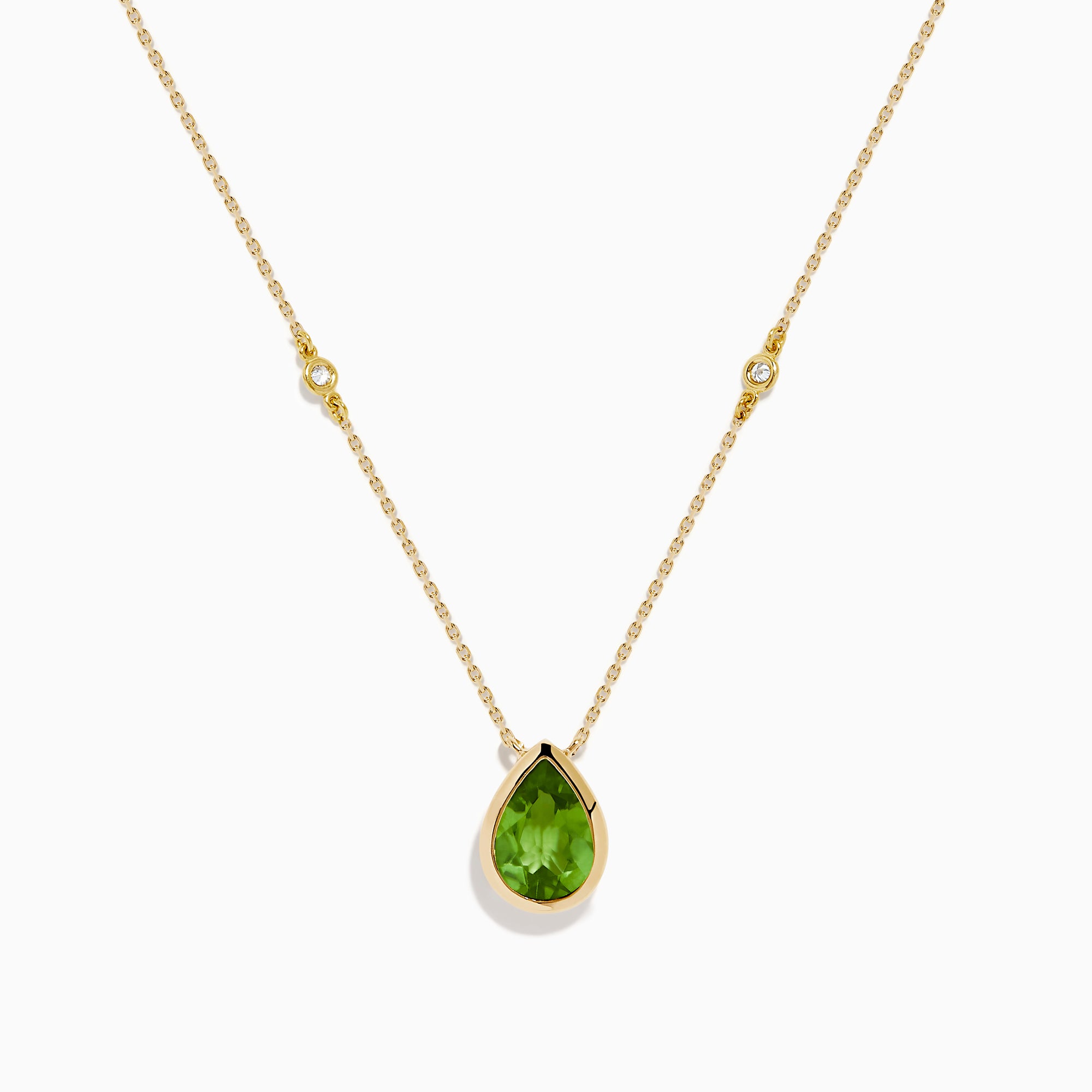 The 14K Yellow Gold Peridot and Diamond Necklace features a delicate gold chain with a teardrop-shaped green peridot pendant and two small round diamonds set along the chain.