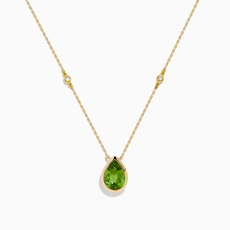The 14K Yellow Gold Peridot and Diamond Necklace features a delicate gold chain with a teardrop-shaped green peridot pendant and two small round diamonds set along the chain.