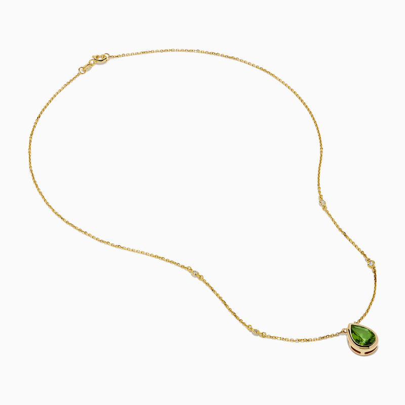 The 14K Yellow Gold Peridot and Diamond Necklace features a delicate gold chain with a teardrop-shaped green peridot pendant and two small round diamonds set along the chain.