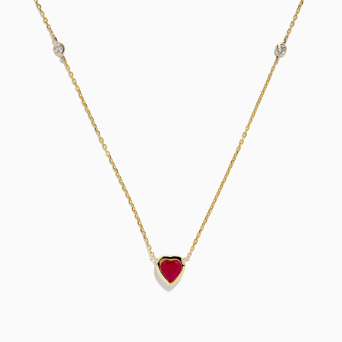 The Ruby Royale 14K Yellow Gold Ruby and Diamond Heart Necklace features a red heart-shaped pendant with a round diamond on each side, displayed on a white background.