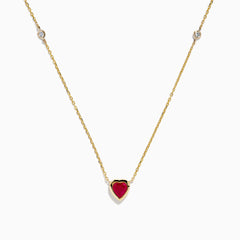 The Ruby Royale 14K Yellow Gold Ruby and Diamond Heart Necklace features a red heart-shaped pendant with a round diamond on each side, displayed on a white background.