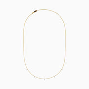 The 14K Yellow Gold Floating Diamonds Beaded Chain Necklace features five small, evenly spaced clear gemstones on a delicate yellow gold chain.