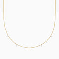 The 14K Yellow Gold Floating Diamonds Beaded Chain Necklace features five small, evenly spaced clear gemstones on a delicate yellow gold chain.