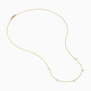The 14K Yellow Gold Floating Diamonds Beaded Chain Necklace features five small, evenly spaced clear gemstones on a delicate yellow gold chain.