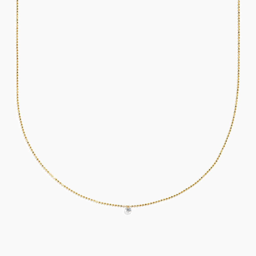 The 14K Yellow Gold Floating Diamond Solitaire Beaded Chain Necklace showcases a small round diamond pendant at the center, set against a plain white background.
