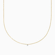 The 14K Yellow Gold Floating Diamond Solitaire Beaded Chain Necklace showcases a small round diamond pendant at the center, set against a plain white background.