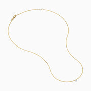 The 14K Yellow Gold Floating Diamond Solitaire Beaded Chain Necklace showcases a small round diamond pendant at the center, set against a plain white background.