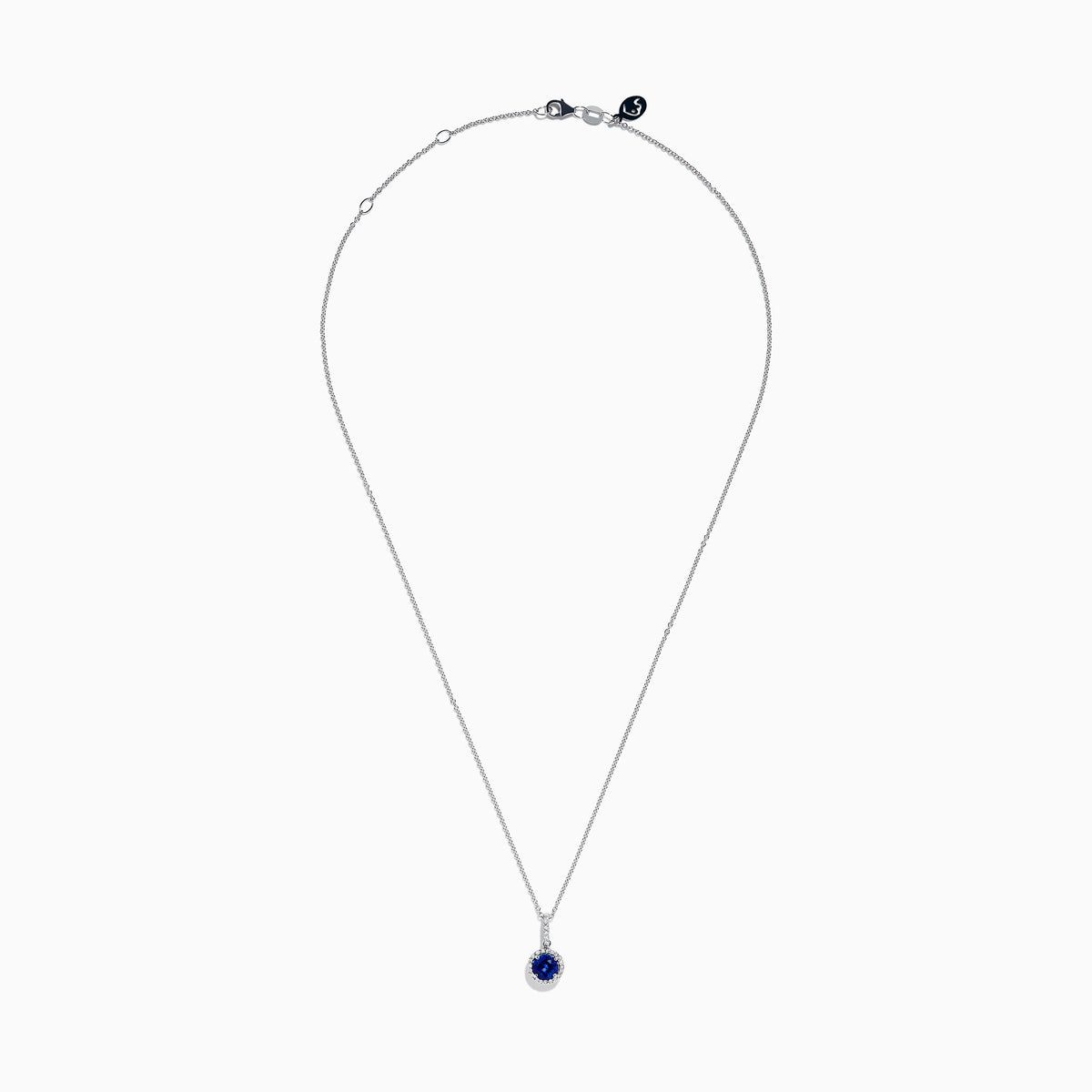 The 14K White Gold Tanzanite and Diamond Halo Pendant showcases a round tanzanite encircled by sparkling diamonds, set on a delicate chain, against a white background.
