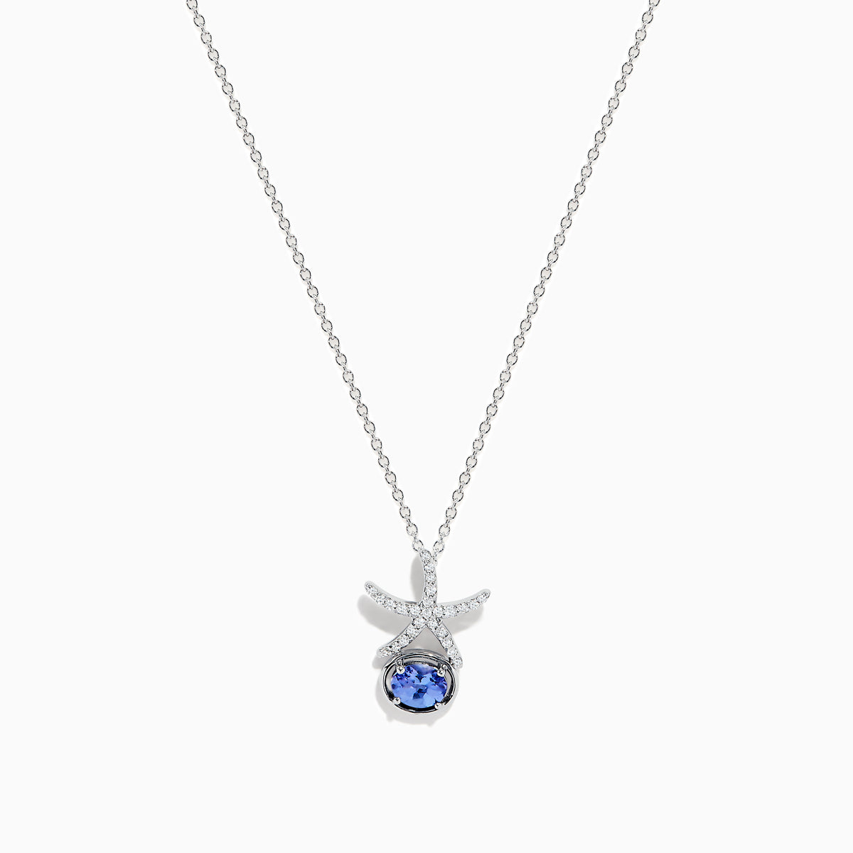 The 925 Seaside Sterling Silver Diamond and Tanzanite Starfish Pendant features a delicate chain and a starfish-shaped design accented with small diamonds and a round tanzanite gemstone at the center.