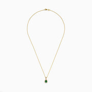The 14K Yellow Gold Emerald and Diamond Pear Halo Pendant features an emerald teardrop surrounded by a diamond halo, set on a gold chain.