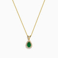 The 14K Yellow Gold Emerald and Diamond Pear Halo Pendant features an emerald teardrop surrounded by a diamond halo, set on a gold chain.