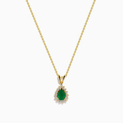 The 14K Yellow Gold Emerald and Diamond Pear Halo Pendant features an emerald teardrop surrounded by a diamond halo, set on a gold chain.