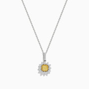 The Canare 18K Two Tone Gold White and Yellow Diamond Pendant features a yellow diamond framed by a halo of white diamonds, set on a fine chain.