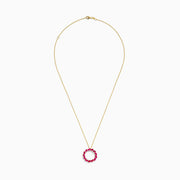 The Ruby Royale 14K Yellow Gold Marquise Cut Ruby Circle Pendant features a circular design with marquise-cut rubies in a wreath-like arrangement.
